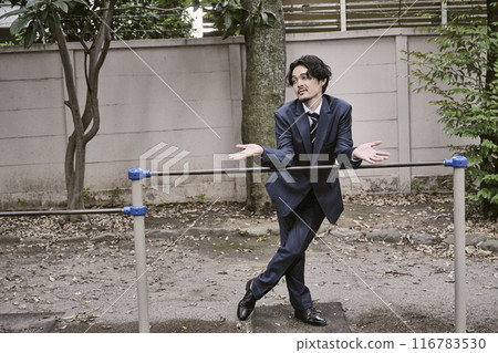 Man leaning on iron bar outdoors 116783530