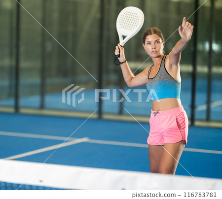 Emotional woman training padel at group workout 116783781