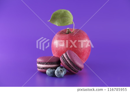 Macarons and fruits over purple background Macarons and fruits over purple background 116785955