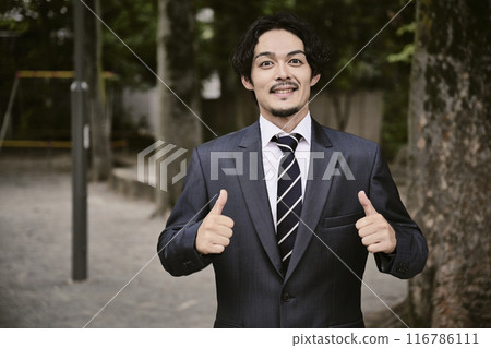 Expressive man in a suit outdoors Expressive man in a suit outdoors 116786111