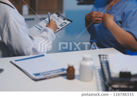 Asian female medical doctor use stethoscope to listen examine check senior elderly patient heart 116786335