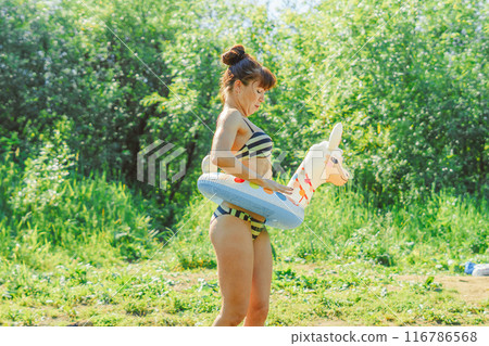 a girl is swimming in the river 116786568