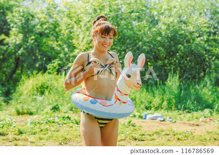 a girl is swimming in the river a girl is swimming in the river 116786569
