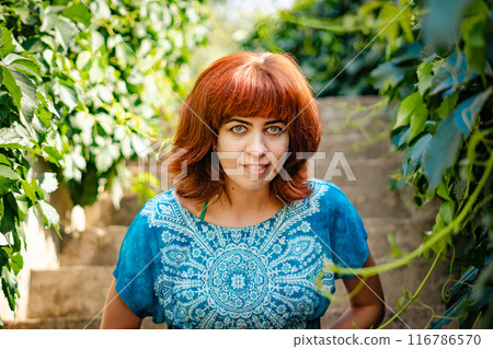 The girl with the red hair in the leaves The girl with the red hair in the leaves 116786570