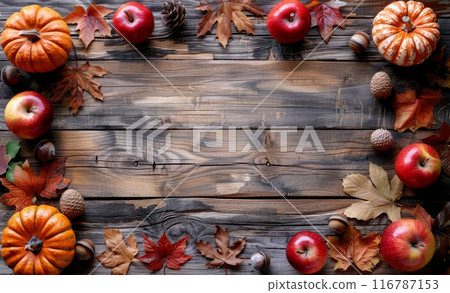 Rustic wooden background with autumn theme featuring pumpkins, apples, and colorful leaves Rustic wooden background with autumn theme featuring pumpkins, apples, and colorful leaves 116787153