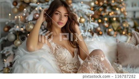 Elegant woman sitting in front of a decorated Christmas tree in a cozy setting Elegant woman sitting in front of a decorated Christmas tree in a cozy setting 116787282
