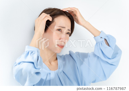 Middle-aged woman worries about hair care 116787987