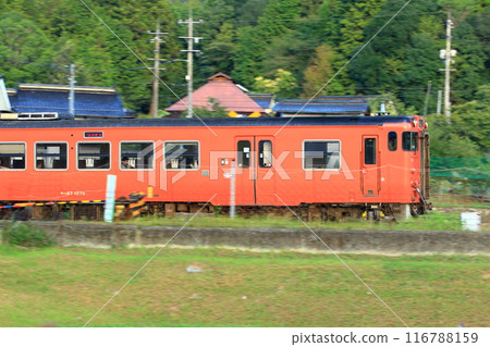 A train running through the countryside in mid-autumn A train running through the countryside in mid-autumn 116788159