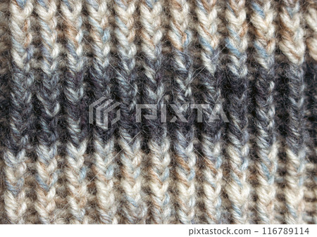 Knitted wool texture, close up. Knitting crochet. Knitting hobby. Striped pattern of wool yarn. Warm winter clothes. Needlework concept. Homemade creativity. Vintage lifestyle. 116789114