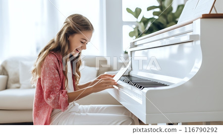 A happy young girl playing the piano at home 116790292