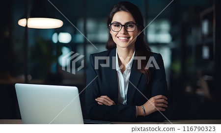 Confident businesswoman in glasses sitting at her desk and smili 116790323