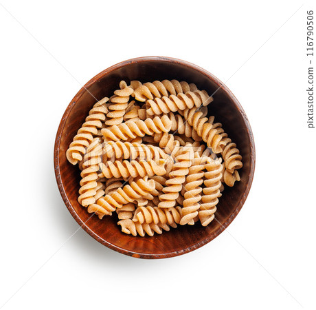 Uncooked whole grain pasta isolated on white background. Raw fusilli  in bowl 116790506