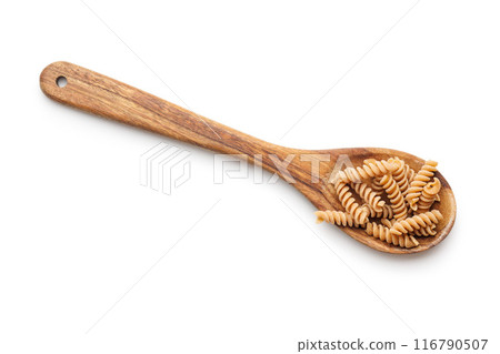 Uncooked whole grain pasta isolated on white background. Raw fusilli  in spoon. 116790507