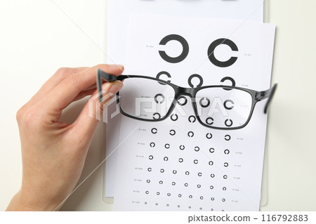Glasses with a label for a paper vision test Glasses with a label for a paper vision test 116792883