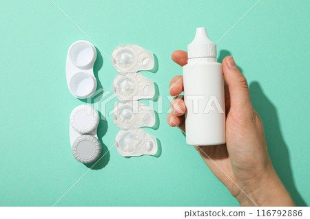 Contact lens liquid with lens container in hand Contact lens liquid with lens container in hand 116792886