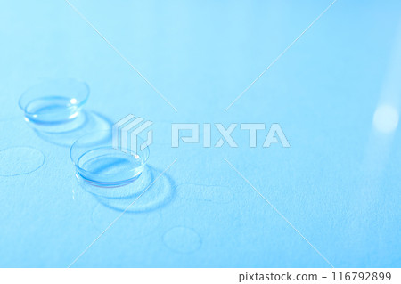 Transparent contact lenses for eyes on a blue background 116792899