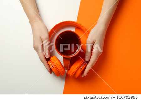 A cup of tea with headphones on a light background 116792963