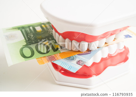 Treatment dental care cost, dental expense or fee, Euro banknote money with teeth model. Treatment dental care cost, dental expense or fee, Euro banknote money with teeth model. 116793935