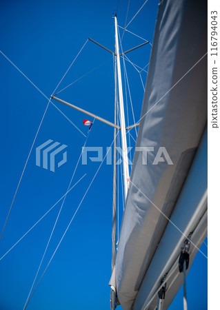 Yacht mast against a blue sky background 116794043