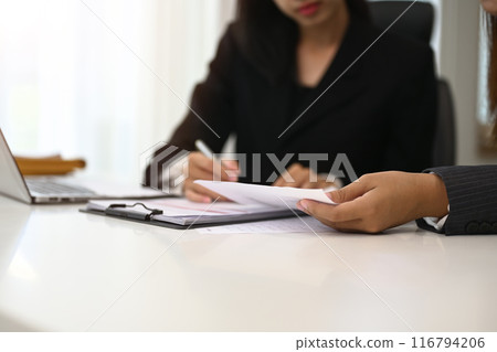 Cropped shot of businesswoman in formal suit explaining strategy to her colleague at office 116794206