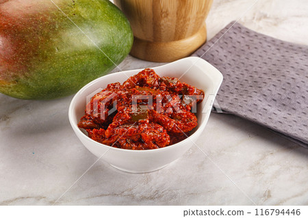 Spicy pickled raw green mango 116794446