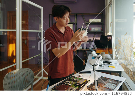 Technician Repairing Router In Workshop 116794853