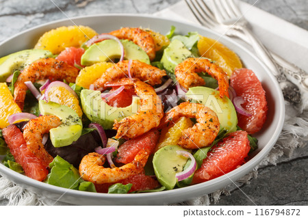 Delicious shrimp salad with oranges, avocado, grapefruit, red onion and leafy greens close-up in a plate. Horizontal Delicious shrimp salad with oranges, avocado, grapefruit, red onion and leafy greens close-up in a plate. Horizontal 116794872