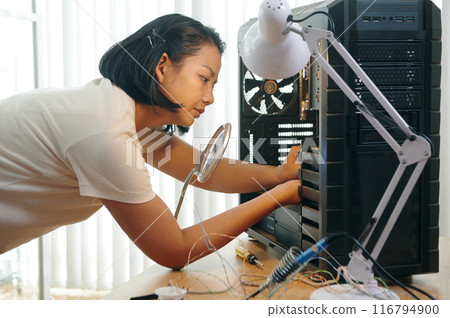 Technician Building PC Computer In Workshop 116794900