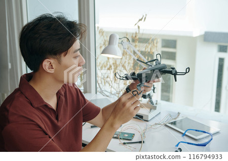 Man Assembling Drone In Workshop 116794933