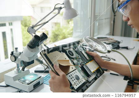 Technician Examining Details Of Laptop 116794957