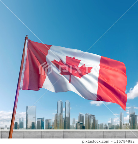 A red and white Canadian flag is flying high in the sky above a city A red and white Canadian flag is flying high in the sky above a city 116794982
