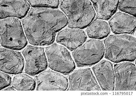 A close up of a stone wall with many small stones 116795017