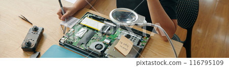 Woman Making List Of Details Of Broken Laptop Woman Making List Of Details Of Broken Laptop 116795109
