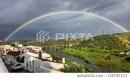 Rainbow over the river Guadiana and the village of Mertola. Alentejo Region. Portugal 116795315
