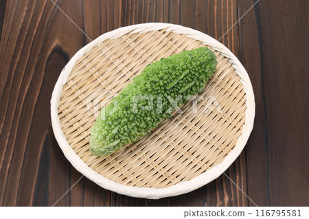 Bitter melon in a colander 116795581