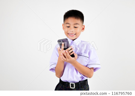 Portrait smiling Asian little boy primary posing holding a cell phone studio isolated white background, happy cute man kid wear school uniform hold smartphone enjoying himself, back to school concept 116795760