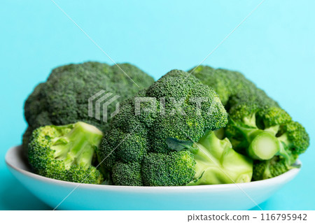 broccoli of fresh green broccoli in bowl over coloredbackground. , close up. Fresh vegetable broccoli of fresh green broccoli in bowl over coloredbackground. , close up. Fresh vegetable 116795942