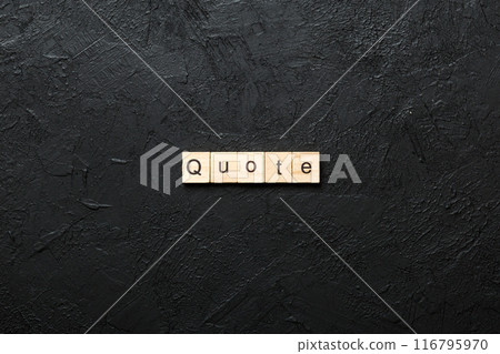 Quote word written on wood block. Quote text on cement table for your desing, concept 116795970