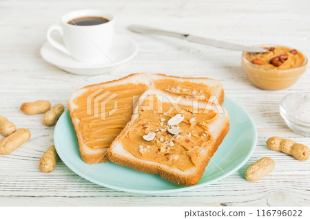 Peanut butter sandwiches or toasts on light table background.Breakfast. Vegetarian food. American cuisine top view vith copy space 116796022