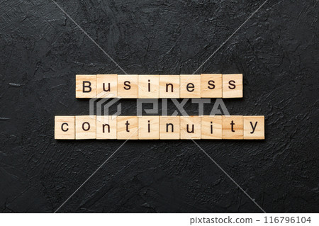 Business Continuity word written on wood block. Business Continuity text on cement table for your desing, concept 116796104