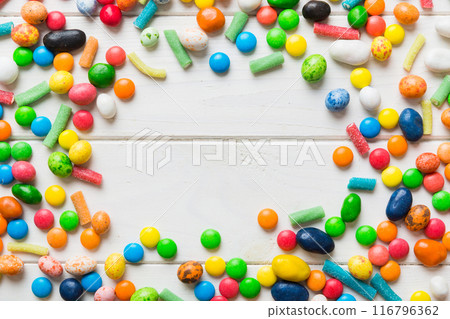 Mixed collection of colorful candy, on colored background. Flat lay, top view. frame of colorful chocolate coated candy 116796362