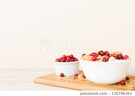 Healthy breakfast food with granola, yogurt, fruits and nuts. Dessert parfait with dried fruits for breakfast 116796363