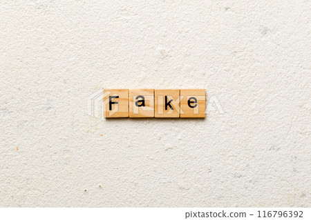 Fake word written on wood block. Fake text on cement table for your desing, concept 116796392