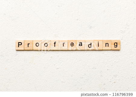 proofreading word written on wood block. proofreading text on table, concept 116796399