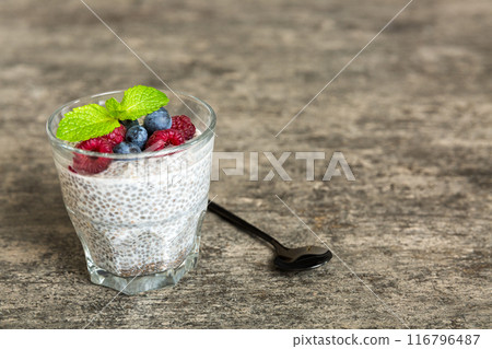 Healthy breakfast or morning with chia seeds vanilla pudding raspberry and blueberry berries on table background, vegetarian food, diet and health concept. Chia pudding with raspberry and blueberry Healthy breakfast or morning with chia seeds vanilla pudding raspberry and blueberry berries on table background, vegetarian food, diet and health concept. Chia pudding with raspberry and blueberry 116796487