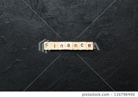 FINANCE word written on wood block. FINANCE text on cement table for your desing, concept 116796498