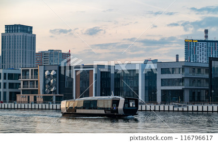 Electric river tram on the Moskva River at sunset on an autumn evening. Electric river tram on the Moskva River at sunset on an autumn evening. 116796617