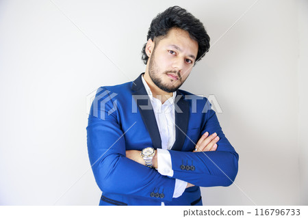 A man in a suit with his arms folded A man in a suit with his arms folded 116796733