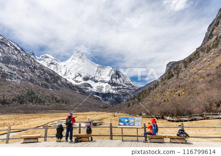 Hikers admiring the breathtaking scenary in Luorong Pasture with Mount Yangmaiyong as backdrop located at Yading nature reserve, Garze Tibetan Autonomous Prefecture, Sichuan. Hikers admiring the breathtaking scenary in Luorong Pasture with Mount Yangmaiyong as backdrop located at Yading nature reserve, Garze Tibetan Autonomous Prefecture, Sichuan. 116799614