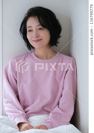 A middle-aged woman having a refreshing morning 116799779